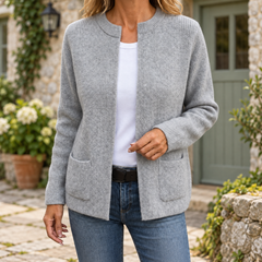 Kerry Zip-Up Knit Cardigan in Grey, shown in an Irish limestone cottage courtyard