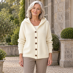 Nuala ivory hooded knit cardigan on a mature model in an Irish courtyard
